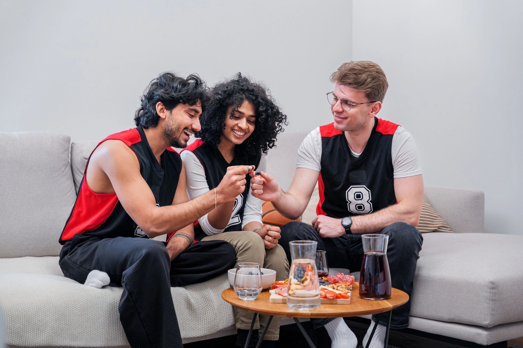Friends watching a game together on a sofa