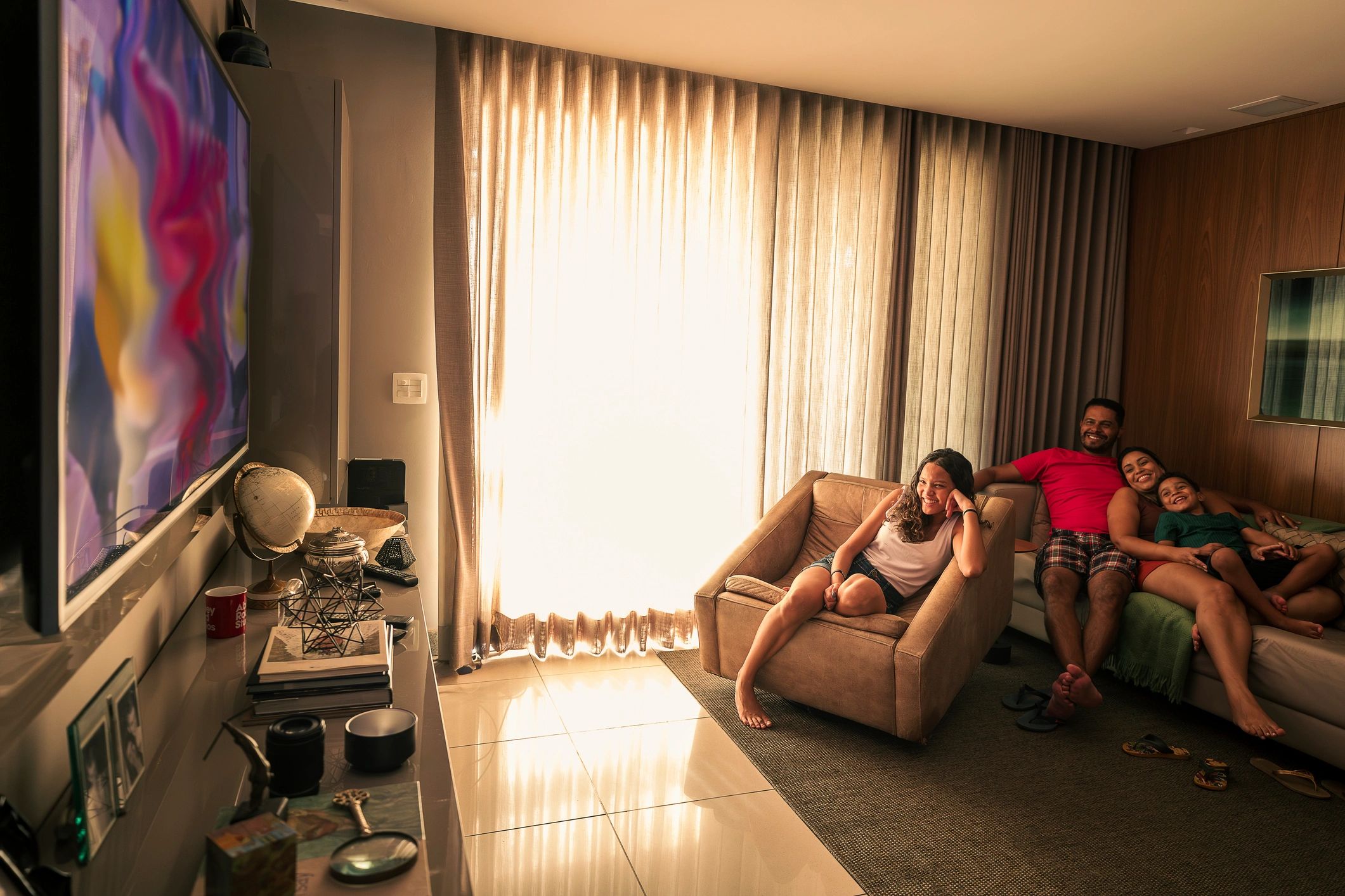 Family watching television together in a living room