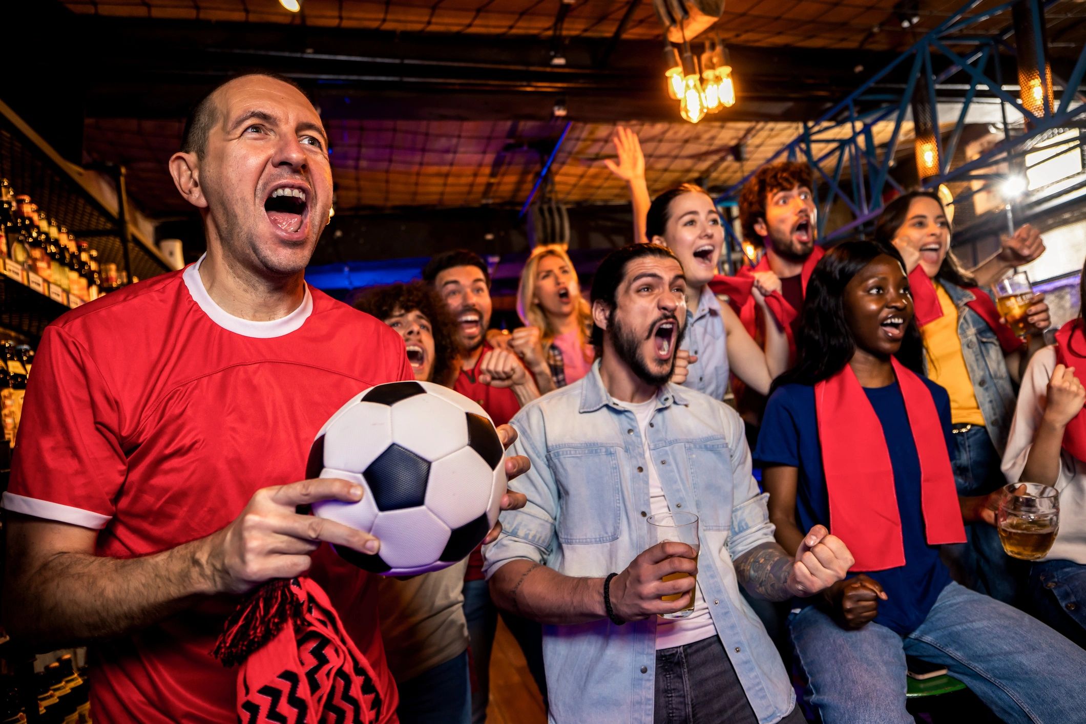 Fans cheering together during a live sports watch party